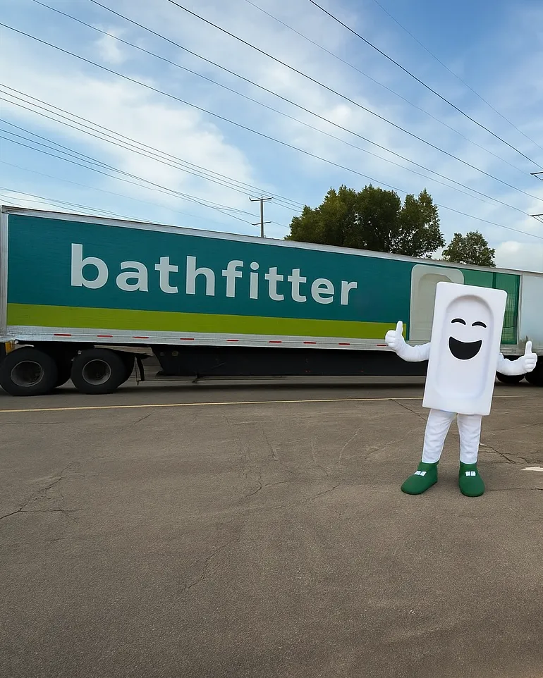 Bath Fitter mascot beside a delivery truck