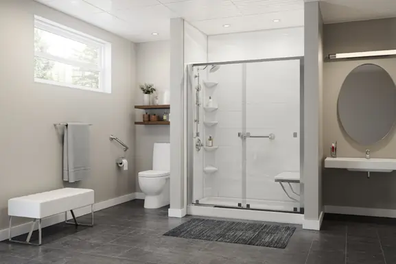 White shower with glass doors, grab bars and a shower seat