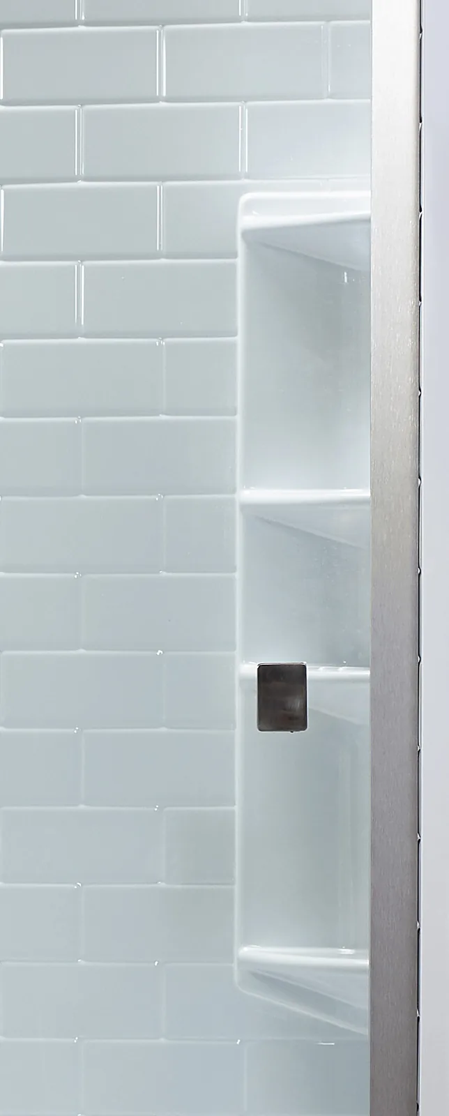 Acrylic corner shelves holding bottles in a white Bath Fitter shower surround