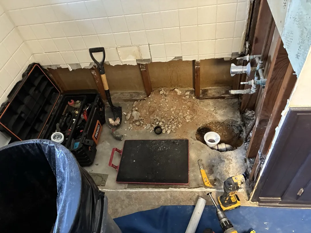 Norman wet area after bathtub removal with exposed lower framing and floor