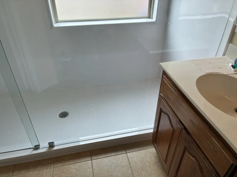 Completed Yukon walk-in shower beneath a window with white walls and clear glass